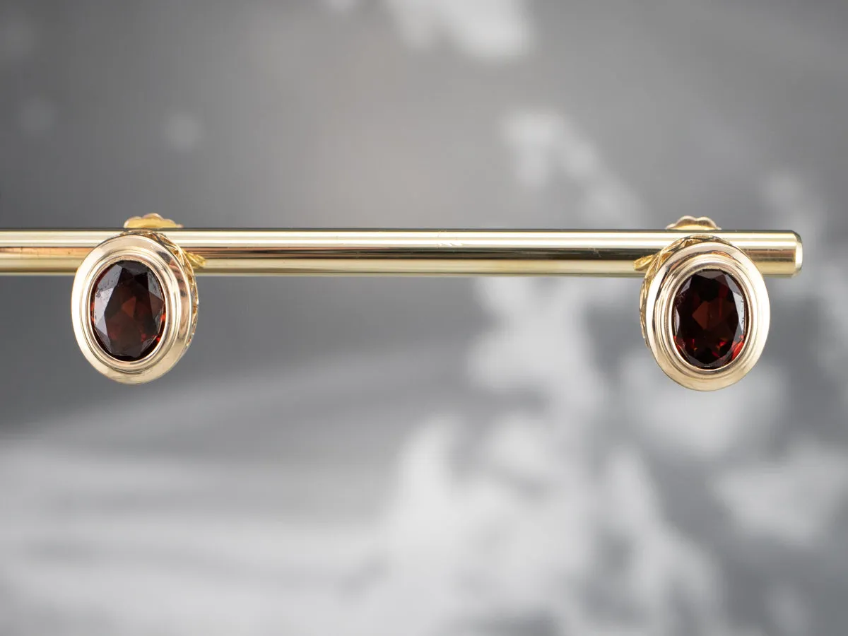 Bezel Set Garnet Stud Earrings in Yellow Gold